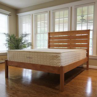 Zenspring organic mattress on a wooden bed frame by Savvy Rest